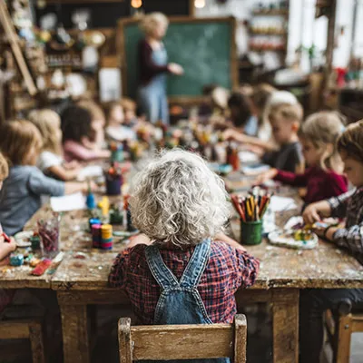 Teacher with young kindergarten students in classroom